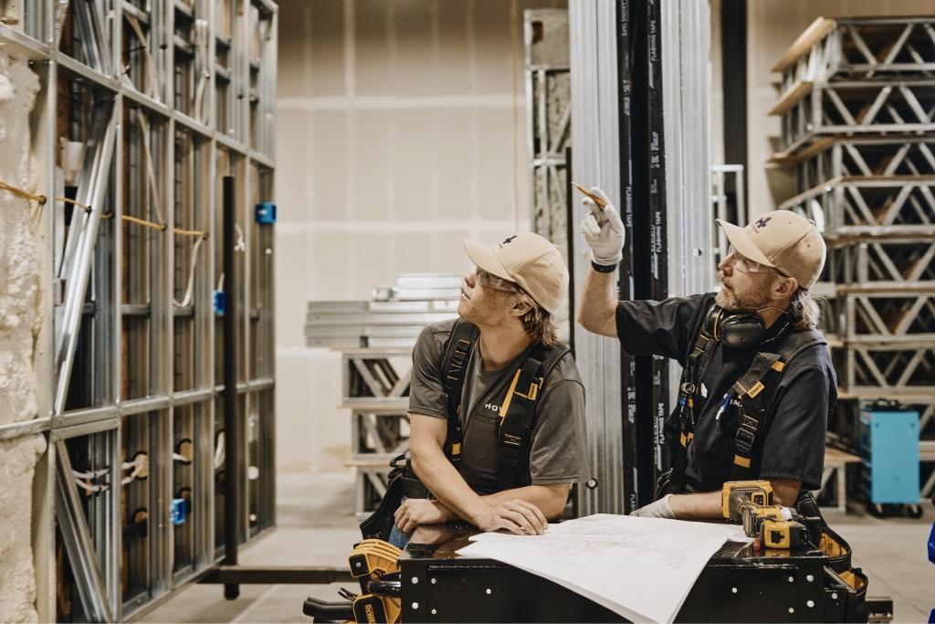 HOWMZ crew assembling a panelized wall in the factory